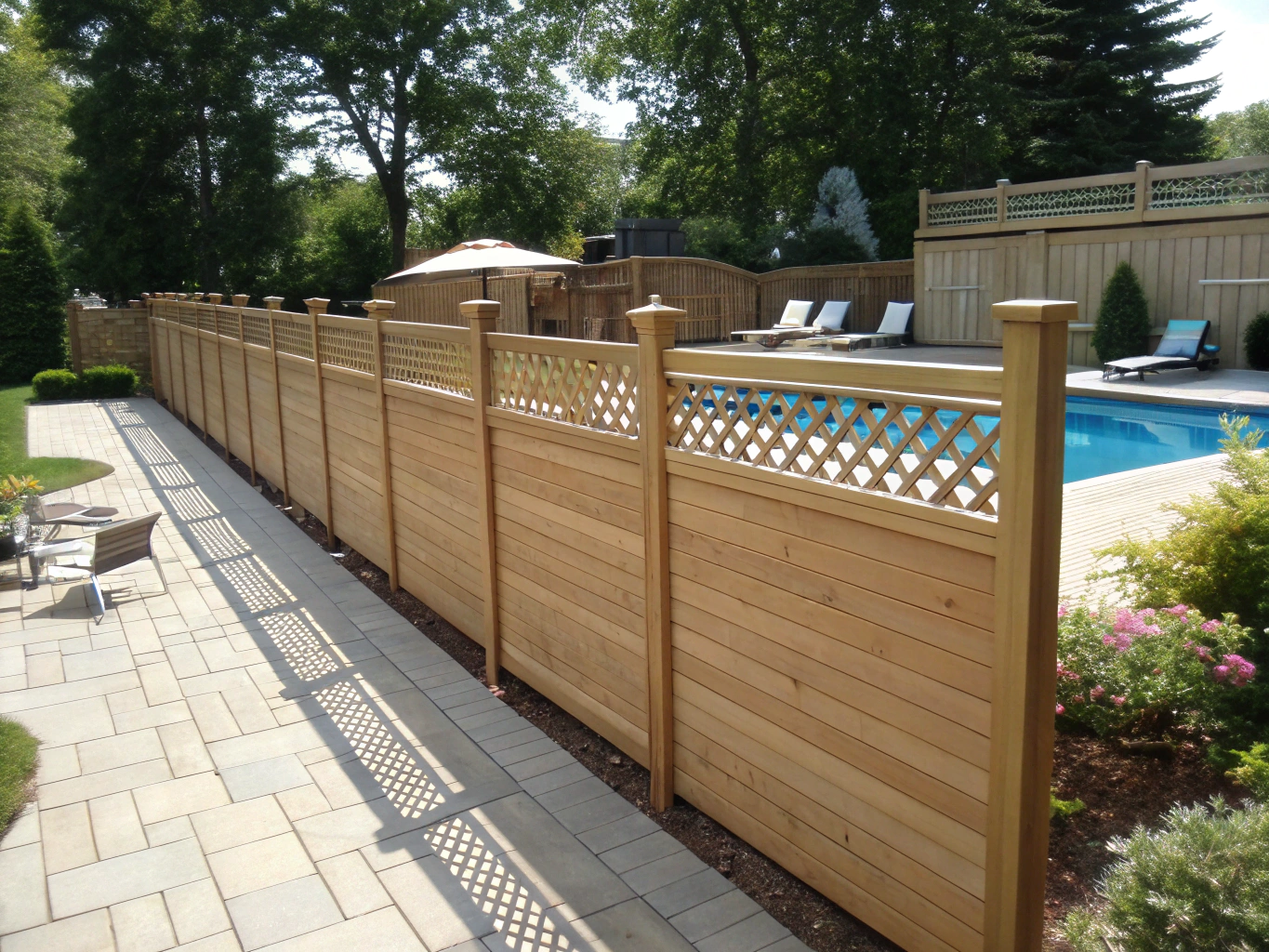 Horizontal hardwood slatted privacy screen in modern courtyard setting